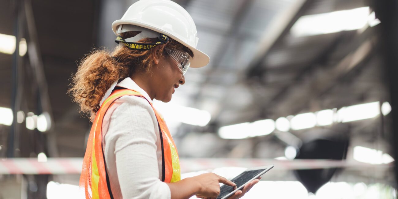 Close up hand industrial industrial plant with a tablet in hand, | Dustcon Solutions